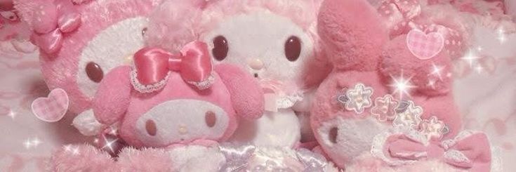 two pink stuffed animals sitting next to each other