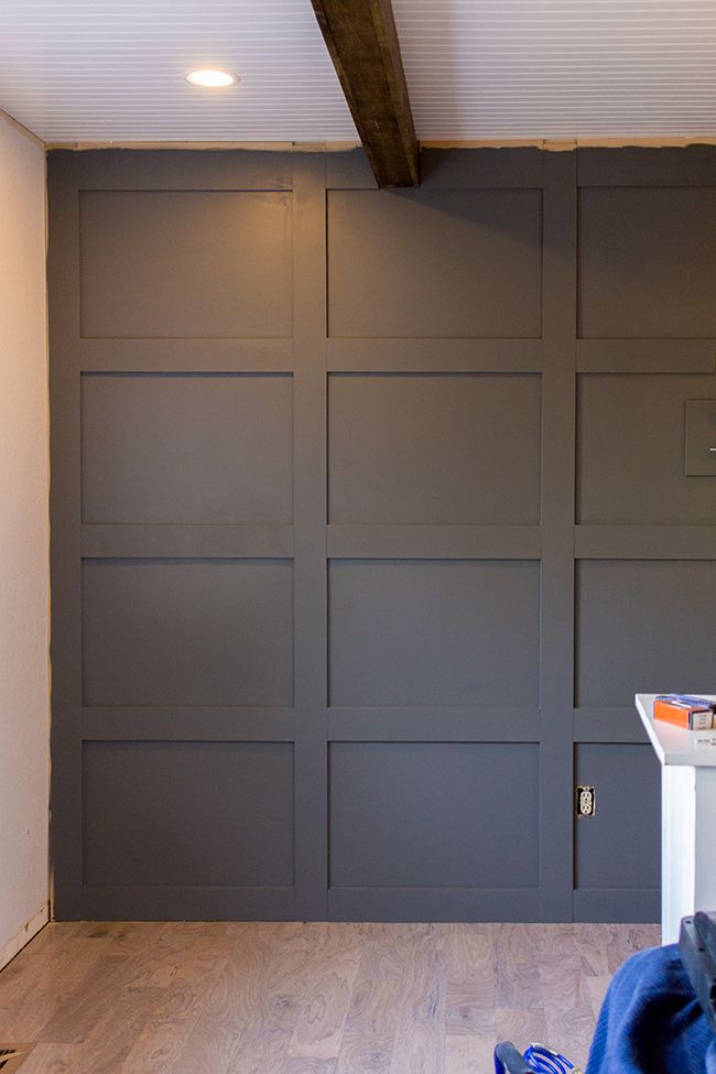 a room with some gray walls and wood floors