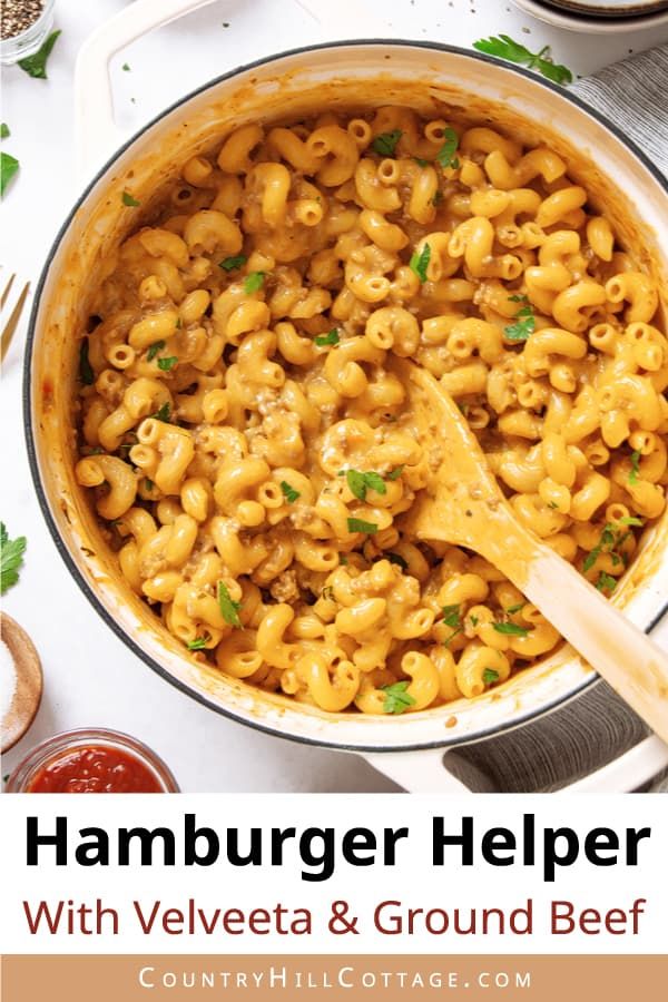 hamburger helper with velveeta and ground beef in a large skillet