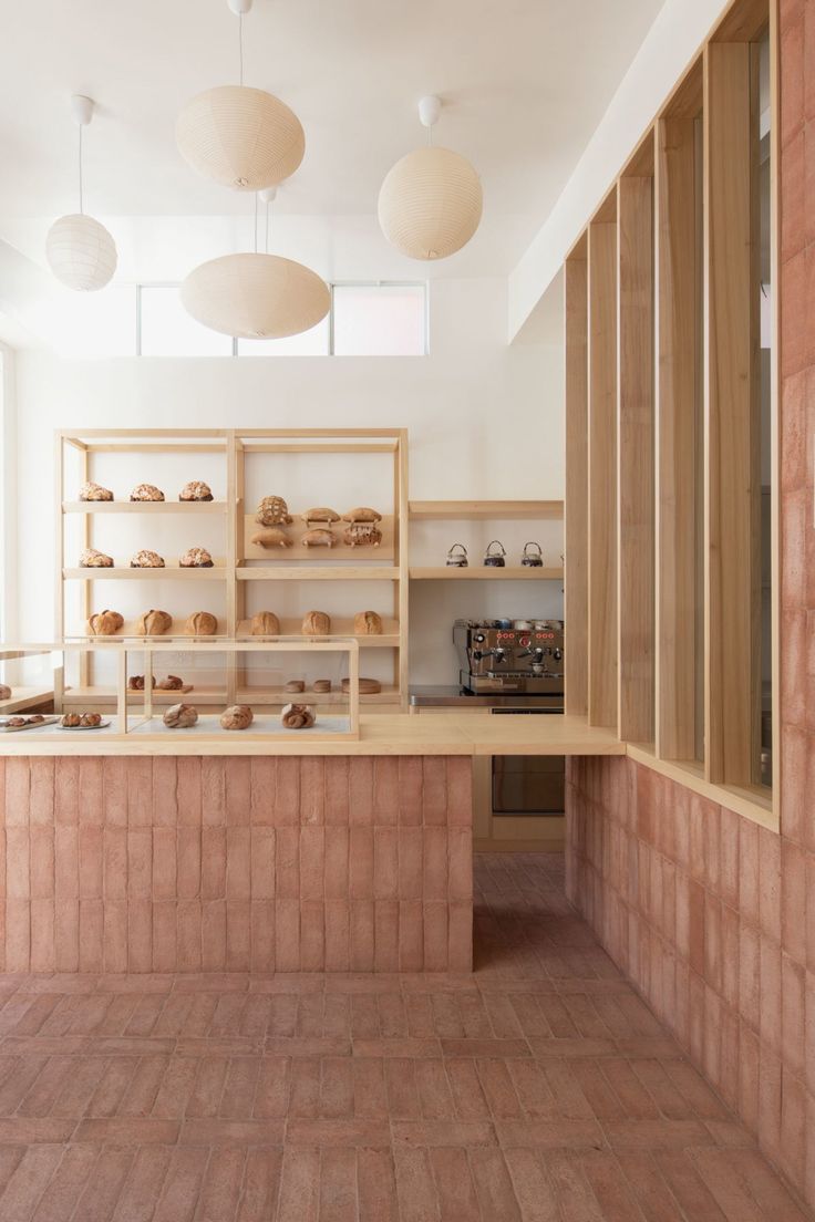 the interior of a bakery with wooden shelves