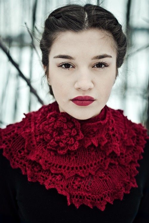 a woman wearing a red scarf and black top