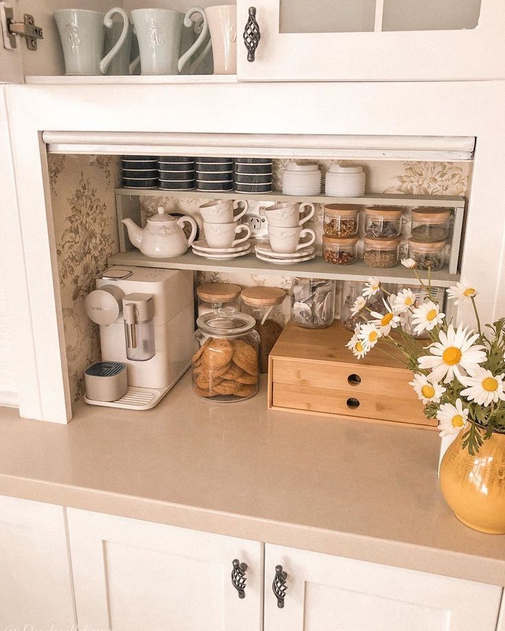 the shelves in the kitchen are filled with dishes and cups