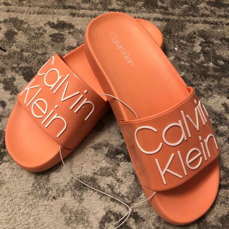 I Have Womens Sizes 6 And 7. These Are Calvin Klein Style Axel Logo Slides. Perfect For The Pool Or Around The House. Comfortable, Durable, And Stylish Slides To Go About Your Day In. The Color Is A Nice Salmon, These Are Unisex Calvin Klein Slip-on Sandals For Summer, Calvin Klein Open Toe Sandals With Cushioned Footbed, Calvin Klein Casual Sandals With Cushioned Footbed, Trendy Calvin Klein Sandals For Spring, Casual Calvin Klein Sandals With Cushioned Footbed, Calvin Klein Casual Slip-on Sandals, Calvin Klein Casual Sandals For Summer, Casual Calvin Klein Slip-on Sandals, Casual Calvin Klein Sandals For Summer