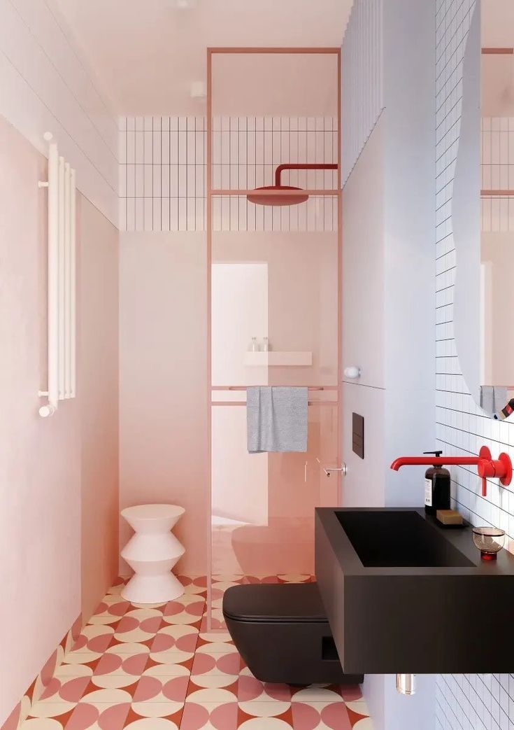 a bathroom with pink and white tiles on the floor