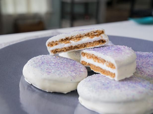 three pieces of cake sitting on top of a plate with white frosting and sprinkles