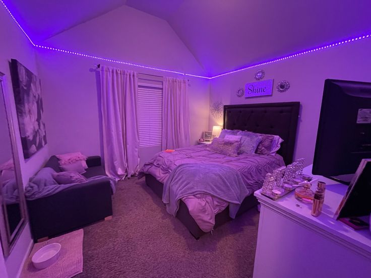 a bed room with a neatly made bed and purple lights on the wall above it