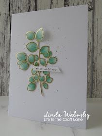 a card with some green leaves on it