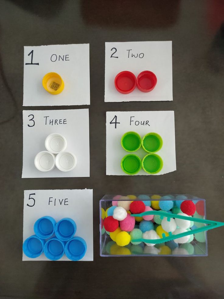 four different types of buttons in plastic containers with numbers on the top and one for each button