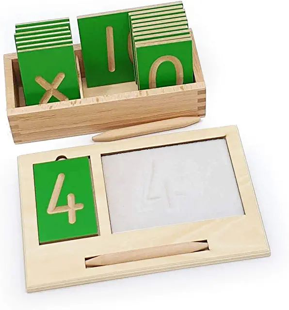 a wooden box with green numbers and blocks in it, on a white table top