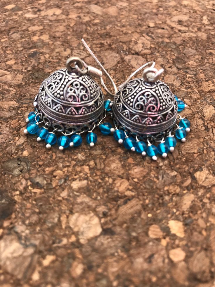 Jhumkas are the calling on the runway ramps this year. This is a traditional artist Jhumki handmade with love. Finished up with beautiful teal drops. A very hot pair for this season. I have made it again as I received many requests to do so. The length of the earrings is 2 inches from top to the tip of the earring. If you want unique this season then these are a pair you must own. Wear temple art and become a part of rich tradition. Thank you for your support Go back to Storefront Taneesijewelry Traditional Handmade Blue Danglers, Fusion Style Jhumkas With Latkans For Celebration, Blue Bohemian Jhumkas For Festive Occasions, Fusion Style Danglers With Latkans For Navratri, Festive Bohemian Blue Jhumkas, Festive Blue Bohemian Jhumkas, Fusion Style Dangle Jhumkas With Latkans, Fusion Style Dangle Jhumkas For Festivals, Fusion Style Jhumkas For Navratri Celebration