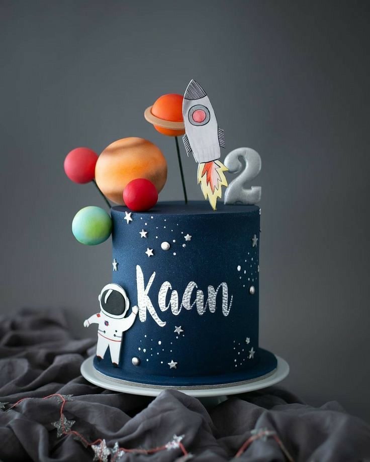 a space themed birthday cake with rockets and planets