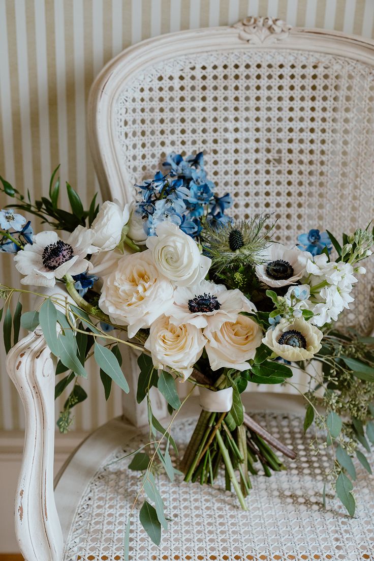 a bouquet of flowers sitting on top of a white chair