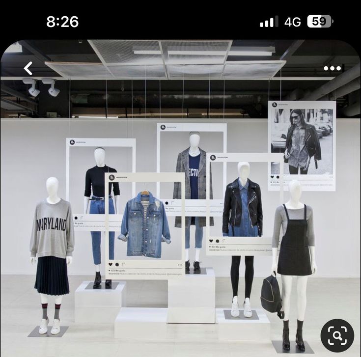 a display case with several mannequins dressed in clothes and jackets on it