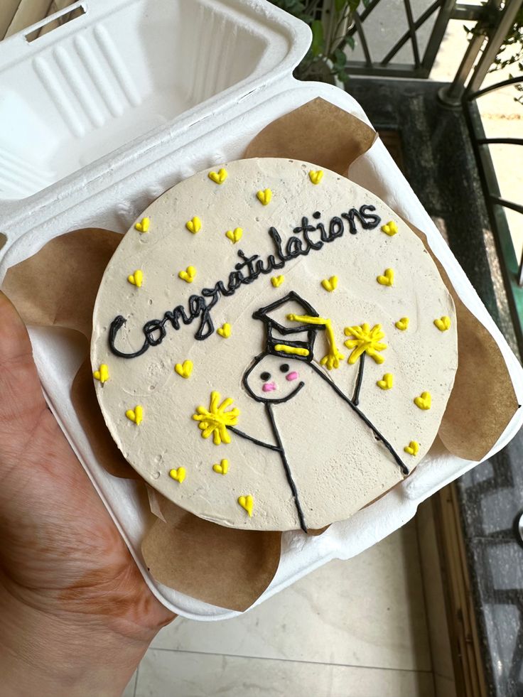 a cake with congratulations written on it in a box