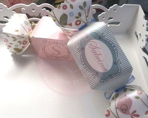 a white tray with some pink and blue items in it on a table next to a teddy bear