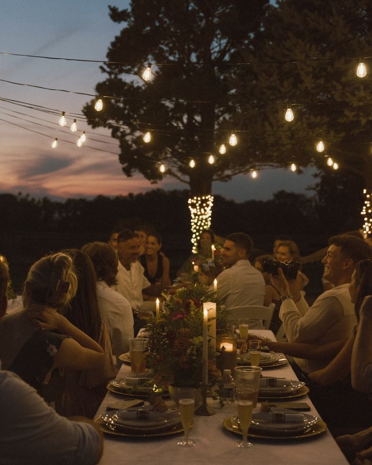 a group of people sitting around a dinner table