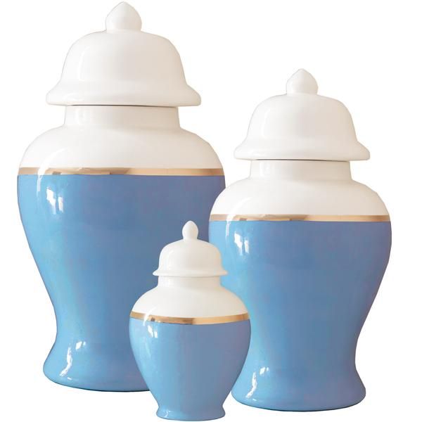 two white and gold vases with lids on them are sitting next to each other