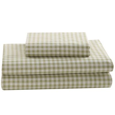 two checkered sheets sitting on top of a white table next to a pair of windows