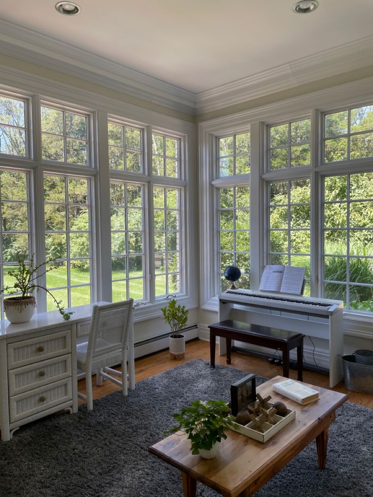 a living room filled with furniture and large windows