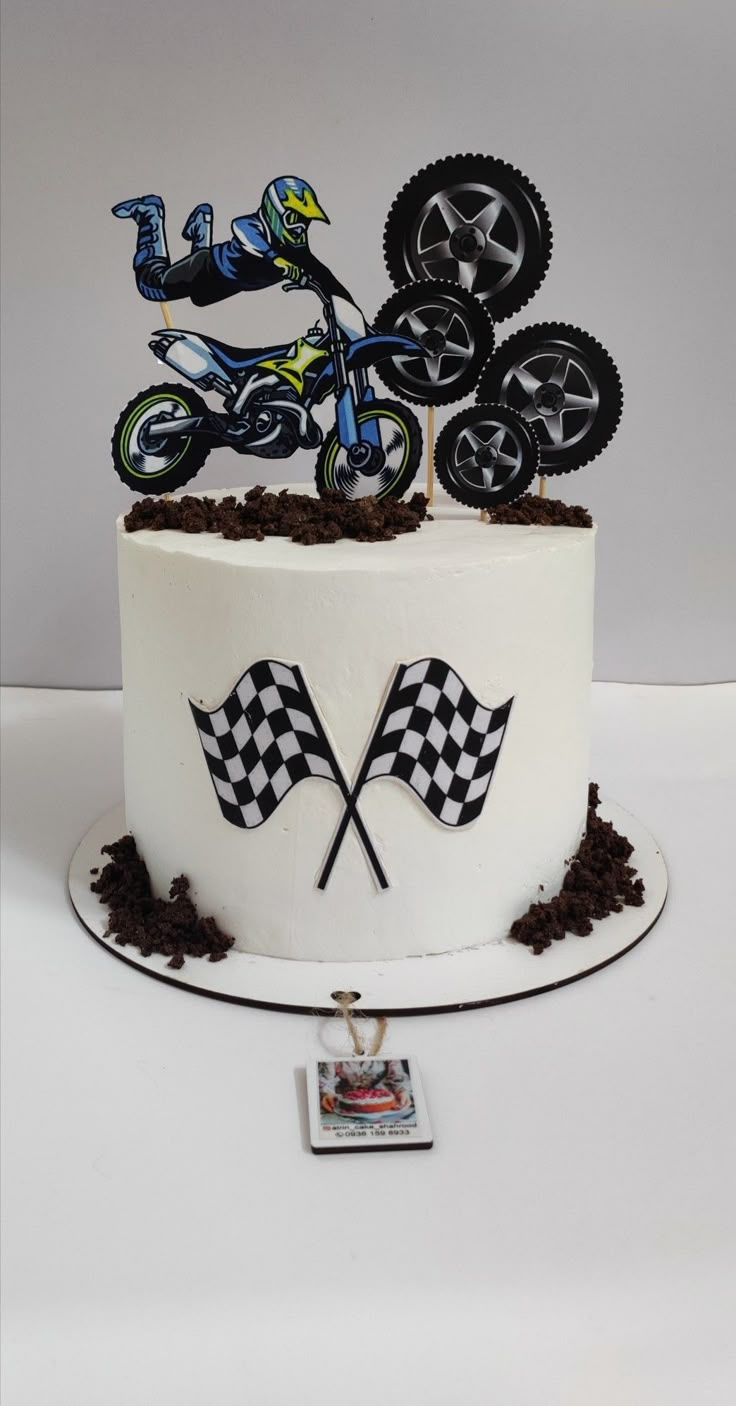 a cake decorated with dirt bikes and checkered flags