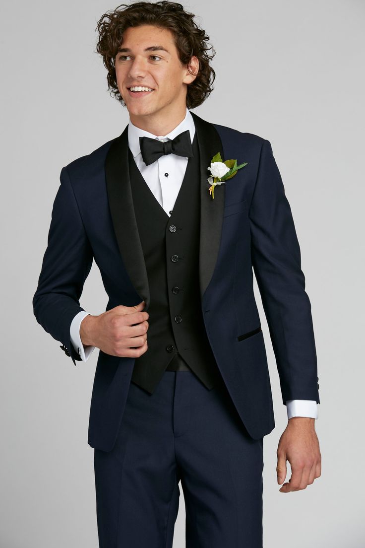 Think timeless, classic tuxedo, and then turn it up. The navy shawl lapel tuxedo is a true style piece, both unexpected and endlessly sharp. A satin, black shawl lapel is set against deep navy blue for a refined contrast. Blue Tuxedo Style Evening Outerwear, Black Tuxedo With Shawl Collar For Wedding, Black Shawl Collar Tuxedo For Wedding, Navy Tuxedo Style Three-piece Suit For Formal Occasions, Navy Tuxedo For Formal Occasions, Black Tuxedo With Shawl Collar, Black Tuxedo Blazer With Shawl Collar, Classic Black Tuxedo With Shawl Collar, Tuxedo Style Blazer With Shawl Collar