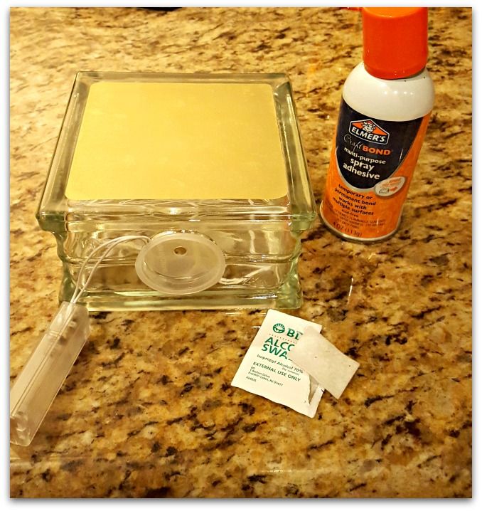 a counter top with some glue and other items on it, including an empty container