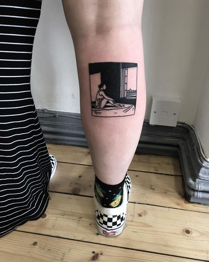 a woman's leg with a black and white photo on the side of her leg