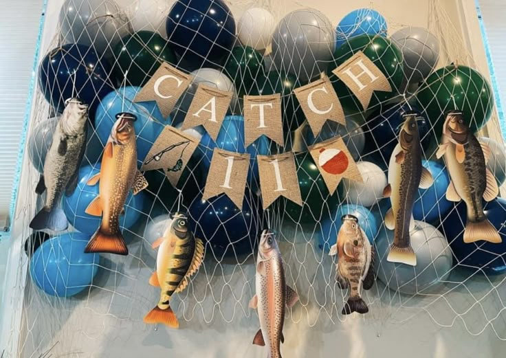 there are fish and balloons hanging on the wall in front of eachother's name