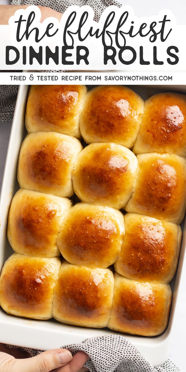 a white dish filled with rolls on top of a table