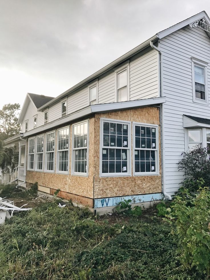 a house that has been boarded up and is in the process of being remodeled