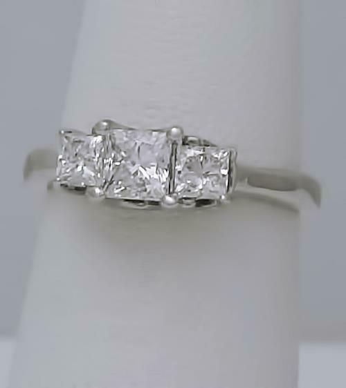 Description Ladies 14k White Gold (not plated or filled) 1.00ct Princess Cut Diamond Three Stone Engagement Ring! GORGEOUS RING! So much nicer in person! Diamond have amazing brilliance and sparkle in person! For diamond color and clarity please see grading below and don't base on the photos as diamonds are hard to capture on camera. Features: FREE appraisal upon request FREE Fedex 2nd day shipping FULLY INSURED Weight: 2 grams Width: 5.4mm Height: 7mm including prongs Diamonds: 3 Princess Cut N Gia Certified Radiant Cut Diamond Wedding Ring, Timeless Gia Certified Princess Cut Wedding Ring, Anniversary Platinum Wedding Ring Radiant Cut, Anniversary Platinum Radiant Cut Ring, White Diamond Ring With Vs Clarity In Asscher Cut, Gia Certified Marquise Cut Cubic Zirconia Wedding Jewelry, Gia Certified Marquise Cut Cubic Zirconia For Wedding, Gia Certified Diamond Anniversary Ring, Gia Certified Diamond White Wedding Ring