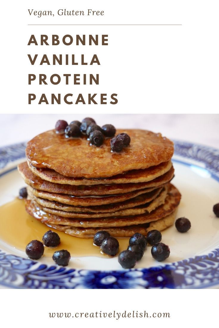 a stack of pancakes with blueberries on top and the words arbonne vanilla protein pancakes