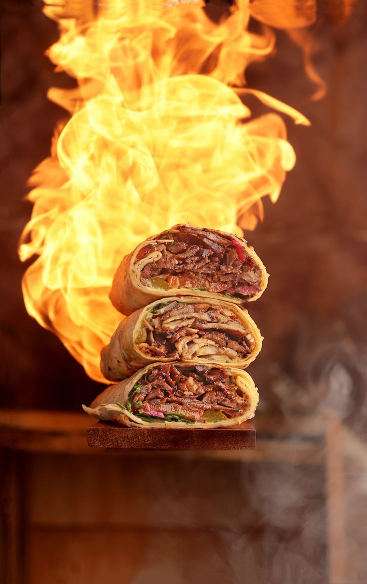 two sandwiches stacked on top of each other in front of fire