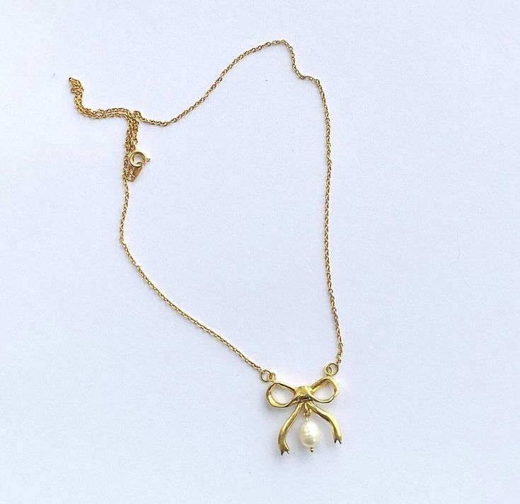 "beautiful Bow Necklace with Freshwater Pearl drop perfect for any occasion. Carved in wax then cast in metal and dipped in a thick layer of 18CT Gold. Hangs on an 18\" gold plated chain. All pieces are handmade to order by UK designer Rebecca Gladstone.  Handmade to order please allow 2-3 weeks for delivery. Your necklace will arrive housed in an embossed gift box. Necklace also available in Sterling Silver option.  Material Composition: Brass/18CT Gold Plating Sterling Silver 925 Freshwater Pearls" Necklace With Pearl, Box Necklace, Bow Necklace, Gold Plated Chains, Pearl Drop, Gold Plated Sterling Silver, Gold Plating, 3 Weeks, Silver 925