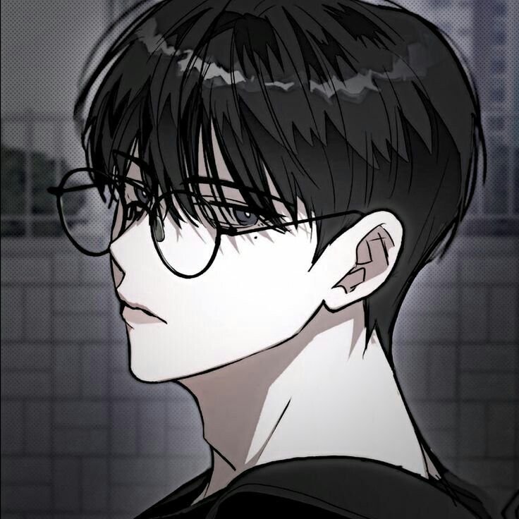 a man with black hair and glasses looking off to the side in front of a tiled wall