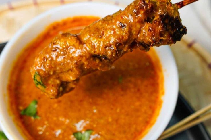 a close up of a skewer of food in a bowl