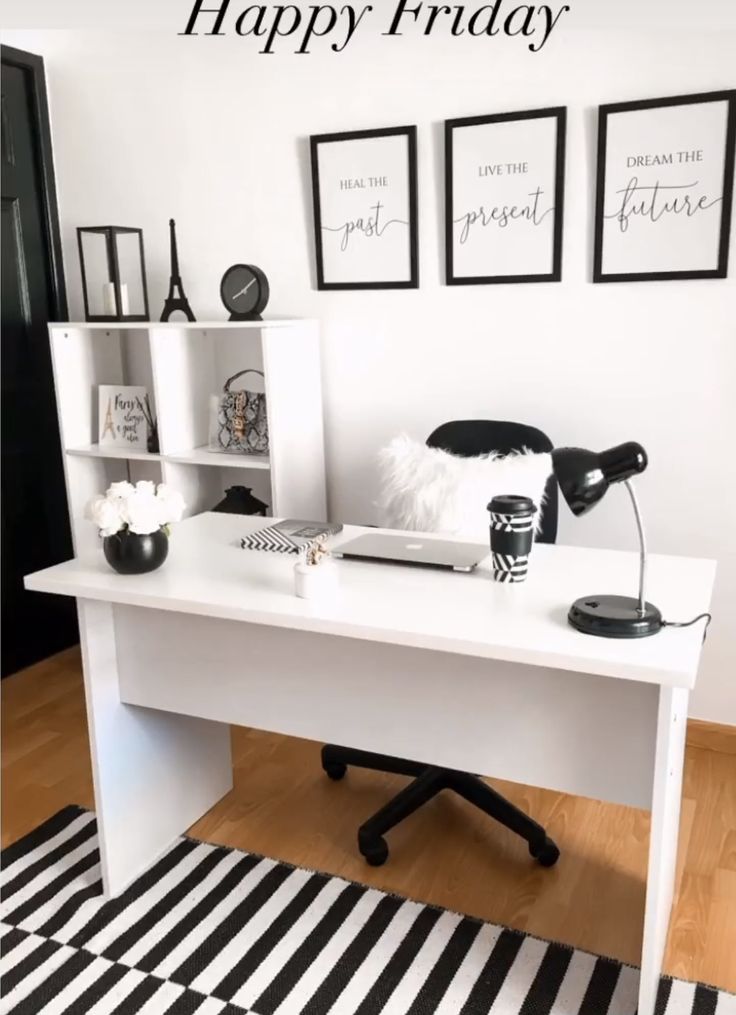 a white desk with black and white decor on it, along with three framed pictures that say happy friday