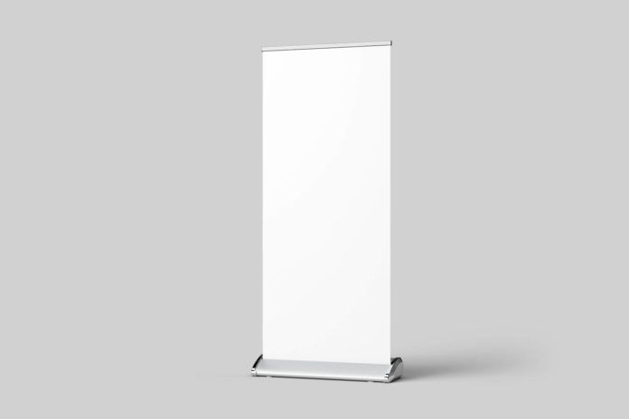 a white roll up banner stand on a gray background with an empty space for text