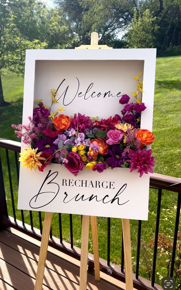 a welcome sign with flowers on it