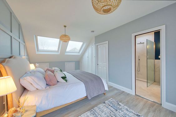 a bedroom with a large bed and skylights