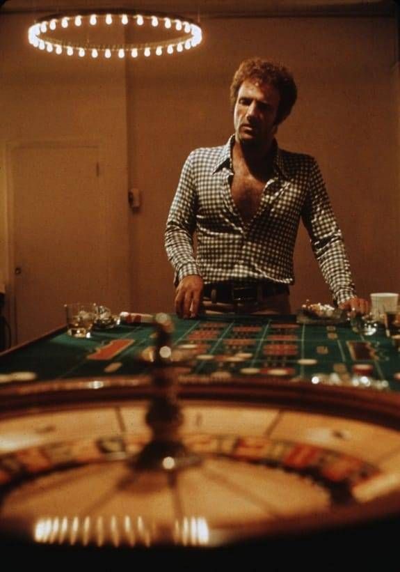 a man standing in front of a casino table