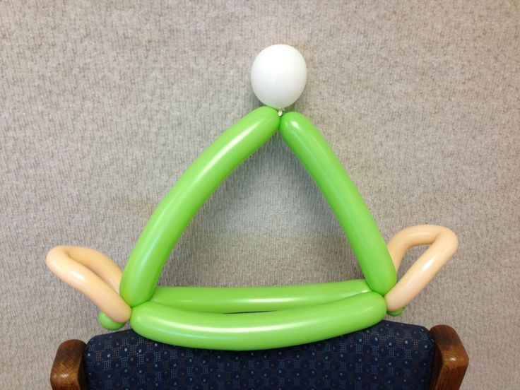 an inflatable green chair with a white ball hanging from it's back