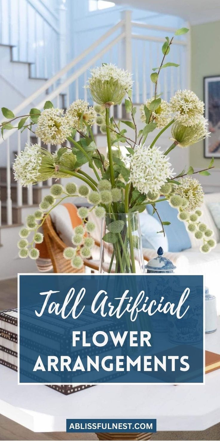 a vase filled with flowers sitting on top of a table next to a stair case