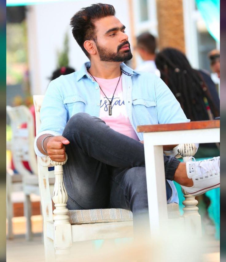 a man sitting on top of a white chair