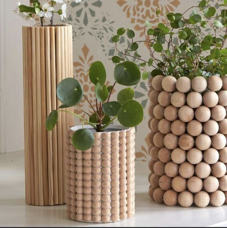 three wooden vases with plants in them