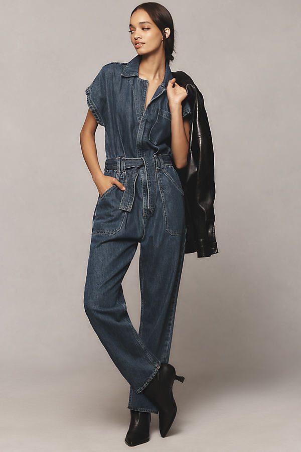 Denim, decoded: We’re digging denim in every corner of our closet. This one-piece wonder by Ética features a notched shirt collar, matching belt, and oversized pockets. | Megg Utility Belted Denim Jumpsuit by Ética in Blue, Women's, Size: XL, Cotton/Tencel at Anthropologie Utility Denim Jumpsuit For Work In Medium Wash, Utility Style Denim Jumpsuit For Work, Casual Denim Jumpsuit With Belt Loops For Work, Chic Denim Belted Jumpsuits And Rompers, Spring Workwear Denim Jumpsuit With Patch Pockets, Spring Denim Jumpsuit With Patch Pockets For Work, Denim Jumpsuit For Work With Belt Loops, Denim Jumpsuit With Belt Loops For Workwear In Spring, Spring Denim Jumpsuit For Work With Belt Loops