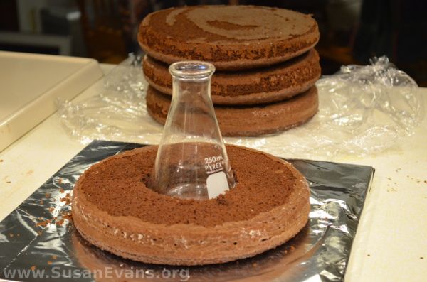 some cookies are stacked on top of each other with a glass bottle in the middle