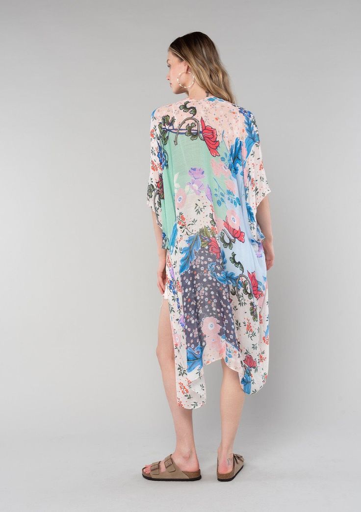 A dreamy lightweight kimono in a natural and coral mixed floral print. Watercolor floral print Relaxed, oversize fit 1/2 length kimono sleeve Mid-length Side vents Open front Bohemian style Embrace the dreamy and laid-back vibes of spring and summer with our mid-length bohemian kimono. Designed with a vibrant floral print, we love to pair this kimono over a swimsuit or as a lightweight outfit topper. The half-length kimono sleeves and open front provide a comfortable and relaxed fit, while the l Pink Floral Print Kimono For Beach Cover-up, Summer Floral Print Sleep Kimono, Affordable Boho, Multicolor Printed Cover-up With Kimono Sleeves, Floral Print Kimono Beach Cover-up, Floral Print Kimono, Bohemian Kimono, Watercolor Floral Print, Multicolor Floral Print V-neck Kimono