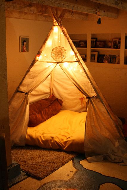 a bed that is in the middle of a room with a light on top of it