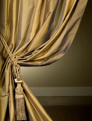 an open curtain with tassels hanging from it's side, and the curtains are